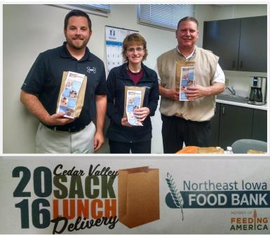 Three members of The Sinnott Agency team posing with sack lunches for the Northeast Iowa Food Bank “Cedar Valley Sack Lunch Delivery” program. 