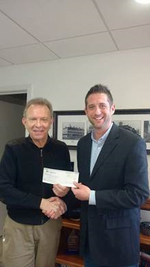 Presenting Dustin Fadiga of the Tiger Track Club with a donation check.