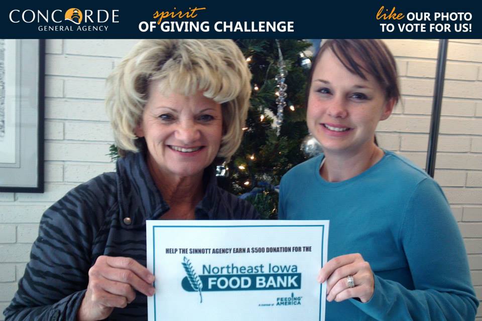 Two of our agents posing for a photo contest for the Concorde General Agency spirit of giving challenge to raise money for the Northeast Iowa Food Bank.