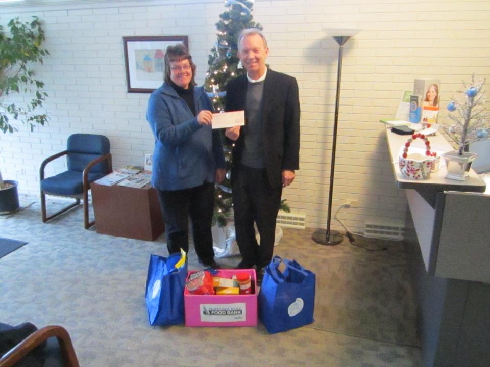 Steve Sinnott presents a $13,000 check to Barbara Prather, Executive Director of the Northeast Iowa Food Bank.